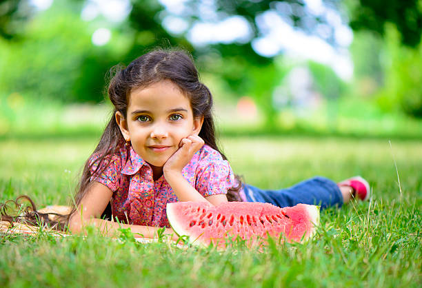 istock Cute hispanic girl eating watermelon 178887171