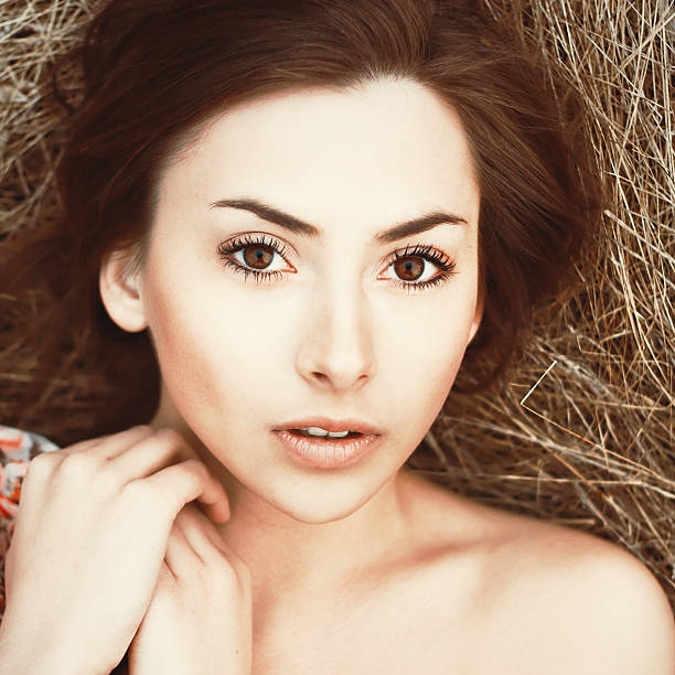 beautiful girl lying on the grass stock photo