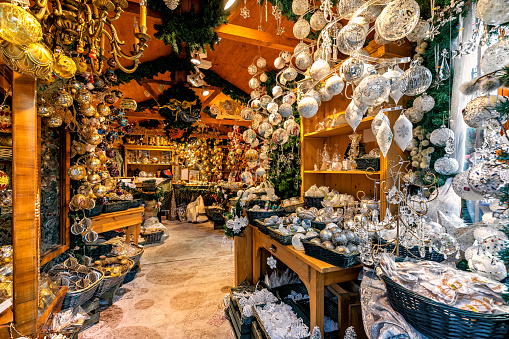 Different types of traditional handmade Christmas decorations on sale inside of small wooden shop in Vienna, Austria.