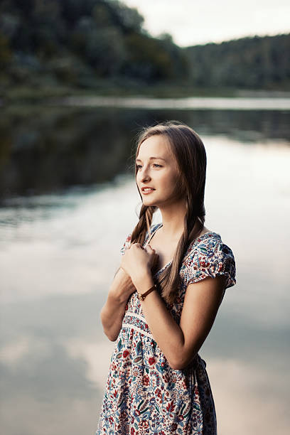 Young lady standing near the river stock photo