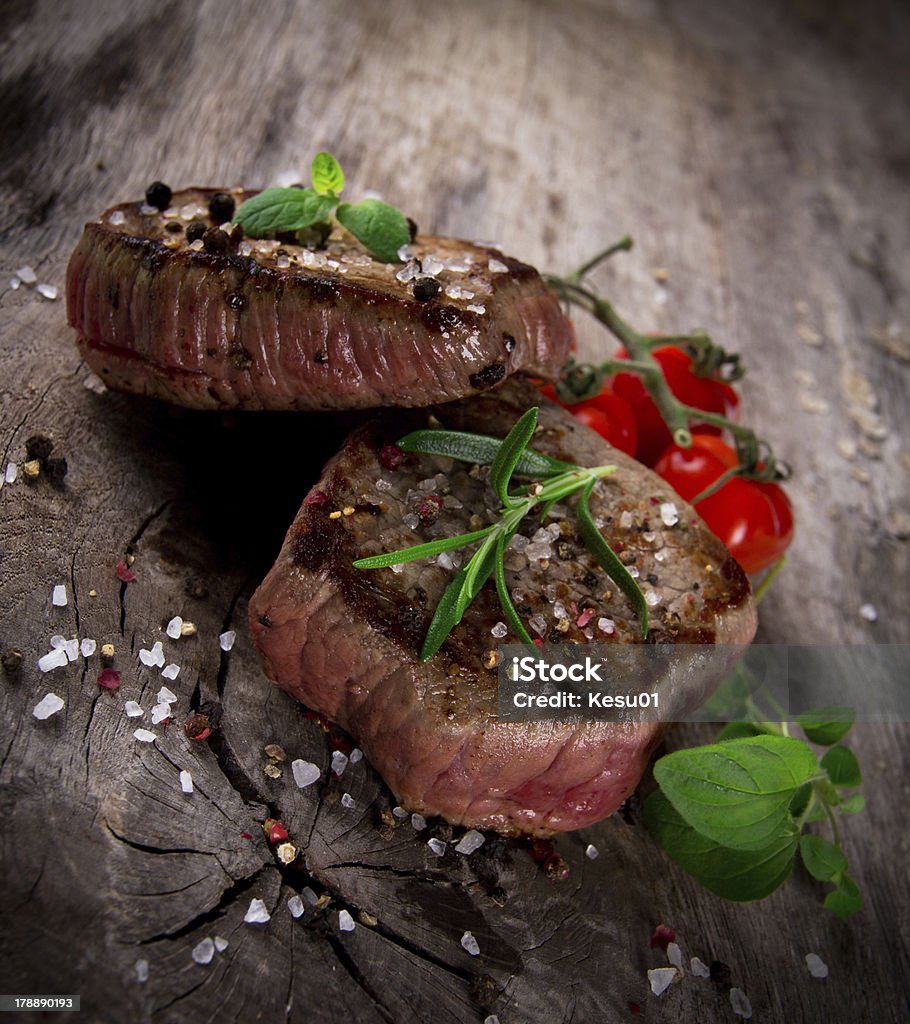 Delicious beef steak Delicious beef steak on wooden table Filet Mignon Stock Photo