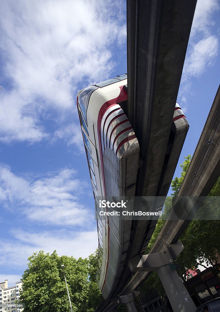 Monorail Transit Train Travels Over Neighborhood Carrying People Downtown A train passes overhead via elevated rail Above Stock Photo