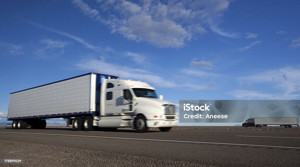 Transportation: Trucking Two trucks pass in alonf a long flat freeway outside of Salt Lake City . Semi-Truck Stock Photo