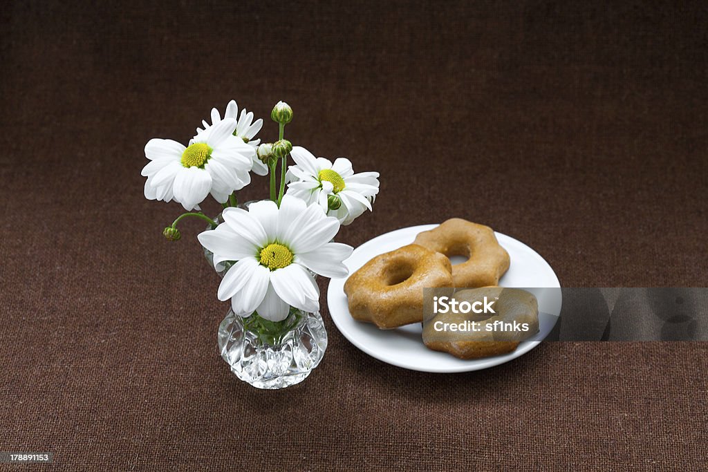 cookies in plate on a background of burlap honey cookies in a white plate, and chamomile on a background of burlap Backgrounds Stock Photo