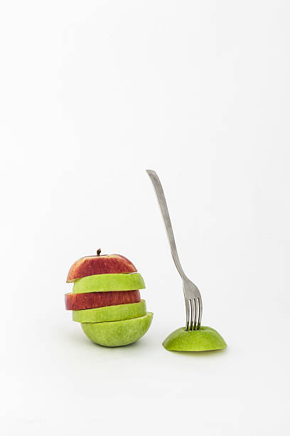istock Red and green apple slices with a fork 178891537