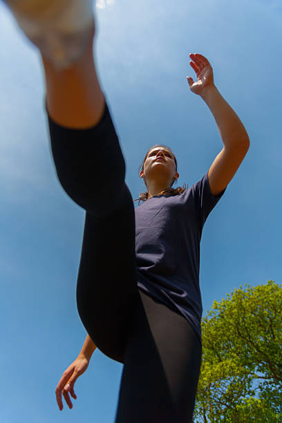 istock Young woman running/jumping Low angle. 178892579