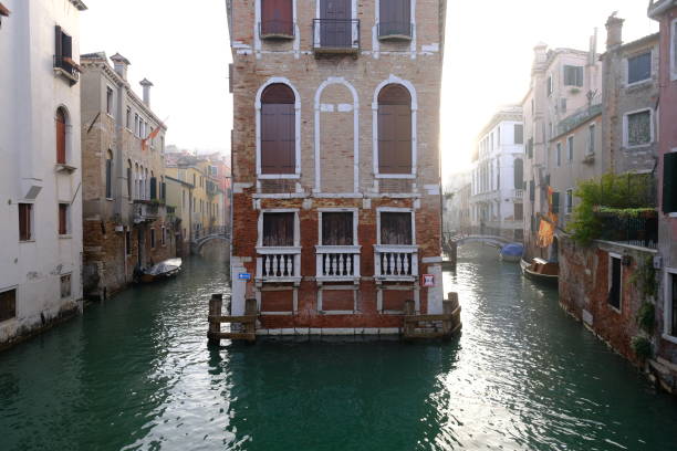 An old Venetian palace surrounded by water. Venice, Italy - November 12, 2023.