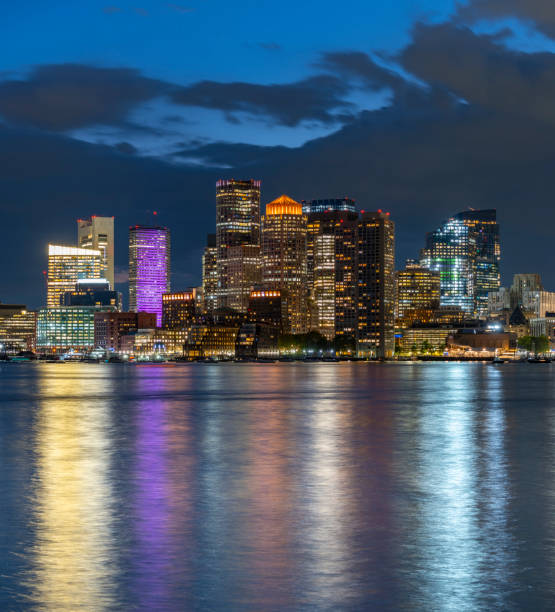 View of the Boston Downtown Skyline from the East at Sunset, Massachusetts, USA Illuminated Skyline with Storm Clouds and Reflection east boston stock pictures, royalty-free photos & images