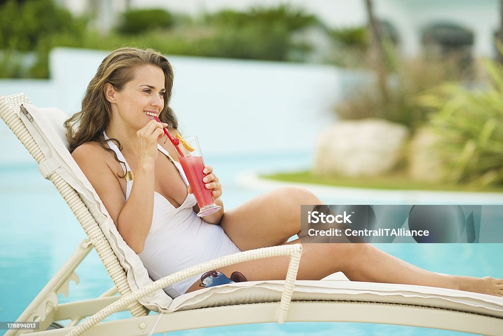 행복한 젊은 여자 힐튼의 sunbed 및 술마시기 칵테일 - 로열티 프리 갈색 머리 스톡 사진