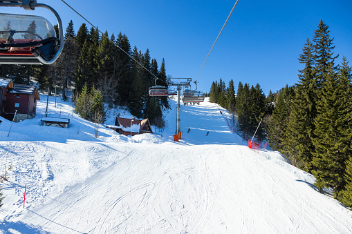 Skiers on ski lift at Jahorina ski resort, Bosnia and Herzegovina.