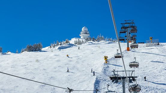 Skiers on ski lift at Jahorina ski resort, Bosnia and Herzegovina.