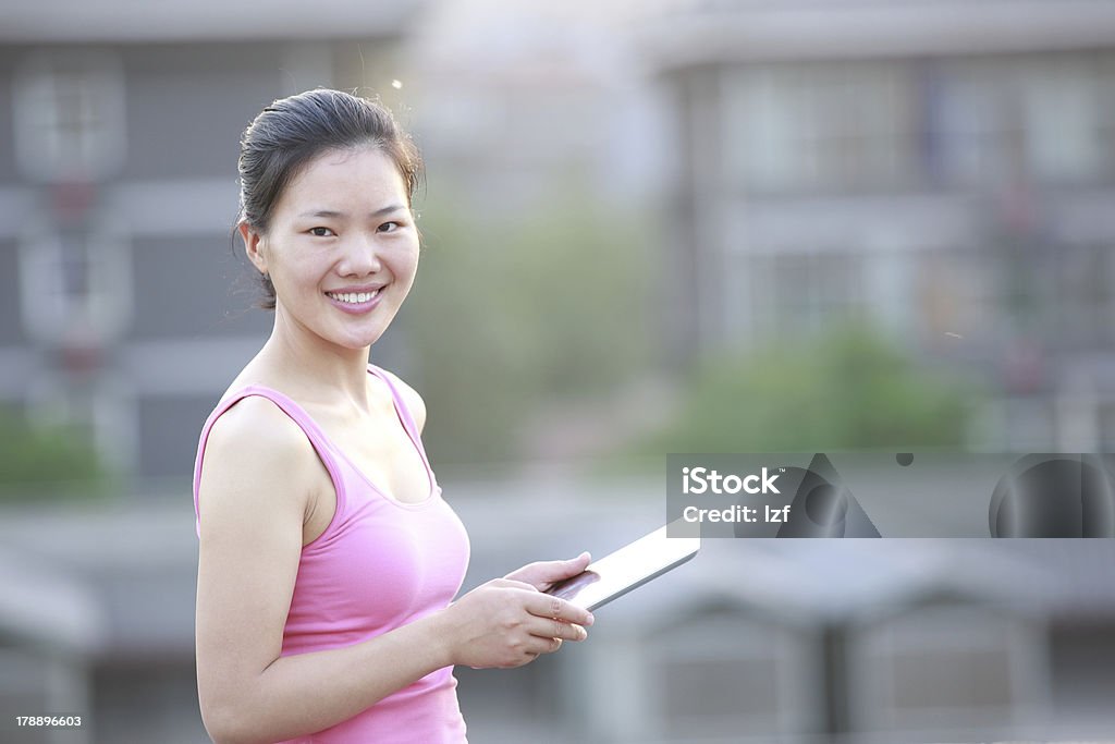 woman use tablet pc young asian woman use tablet pc at xian city wall ,china Adult Stock Photo