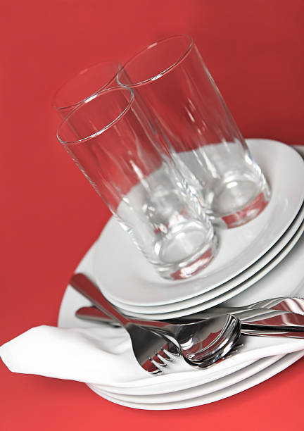 istock Pile of white plates, glasses, forks, spoons. 178897088