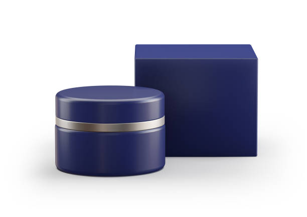 An open round metal tin with its lid rests on a bright red background, creating a strong color contrast. The container's light contents are visible inside, giving the minimalist shot a dramatic and expressive look.