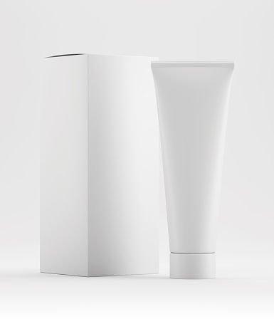 Realistic white glossy cosmetic tube mockup with packaging box as a flatlay with copy space for logo, text or design on a plain white background as 3d rendering.