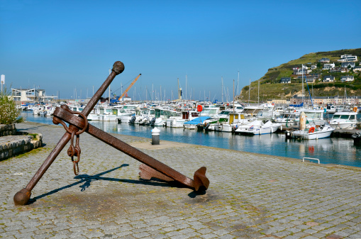Fishing boat moored to harbor dock.Ropes around mooring post. O Grove, Pontevedra province, Galicia, Spain.