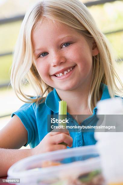 Girl Eating Lunch At Kindergarten Stock Photo - Download Image Now - Child, Eating, Education