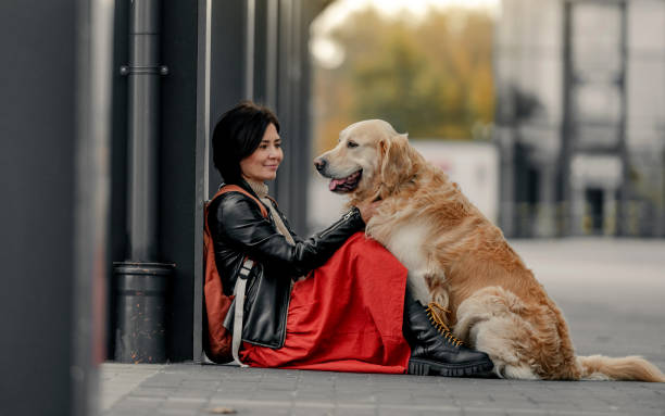 istock Young woman sitting outdoors with her dog 1788990222
