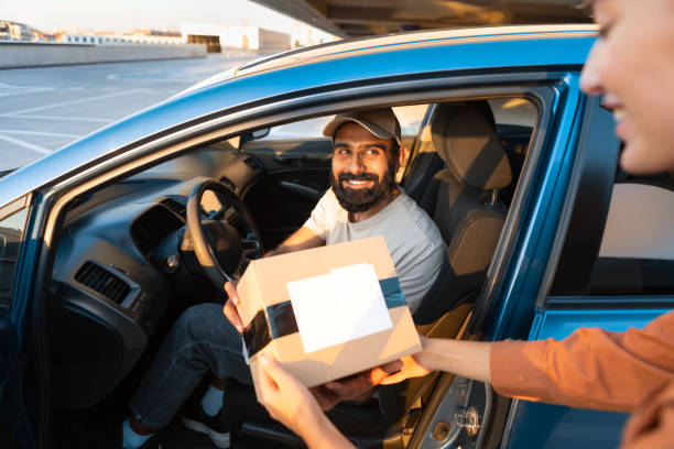 istock Arabic Courier Guy Giving Parcel Box To Customer From Car 1788993529