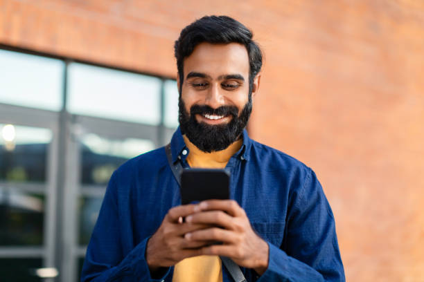 istock Portrait Of Smiling Bearded Arabian Man Using Smartphone Application Outdoor 1788994086