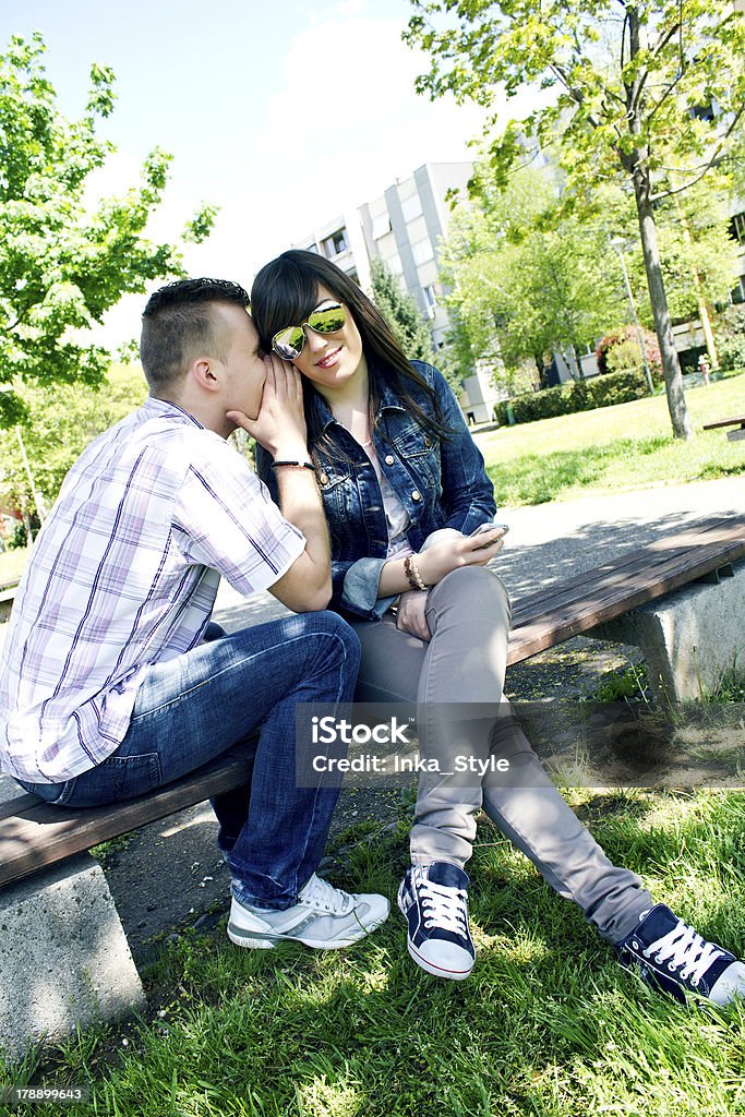 Young couple Whispering the secrets. Adult Stock Photo