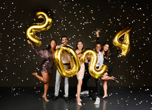 istock Happy multiethnic millennials celebrating New Year 2024 together, black background 1789001502