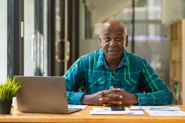 istock A senior black man using a laptop in an office. 1789002075
