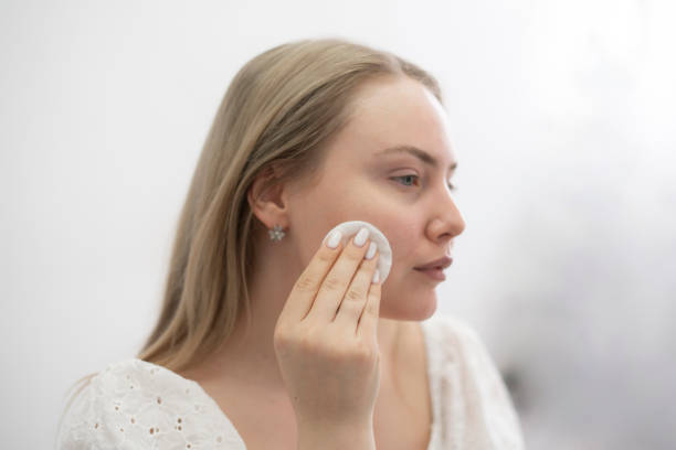 istock pretty young woman doing everyday routine, removing her makeup with a cotton pad 1789004852