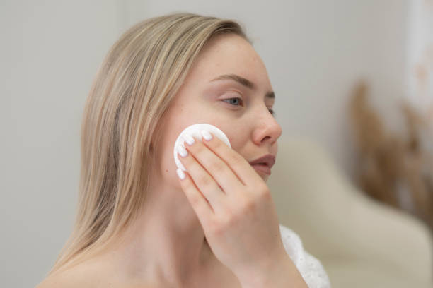 istock pretty young woman doing everyday routine, removing her makeup with a cotton pad 1789004859