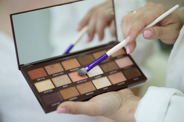 istock a professional stylish makeup artist holding eye shadows palette 1789005481