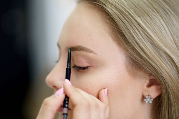 istock a young woman during eyebrow mapping procedure by professional visagist 1789005493