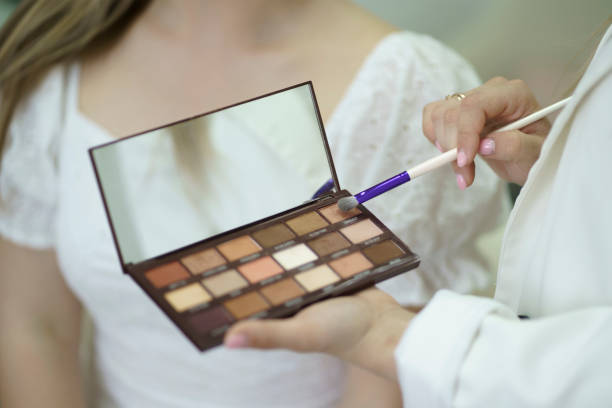 istock a professional stylish makeup artist holding eye shadows palette 1789005521
