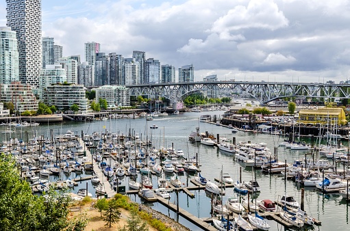Vancouver, British Columbia, Canada, August 9, 2021: Boats berthed at the Fisherman Wharf piers in False Creek marina close to Granville Island and bridge