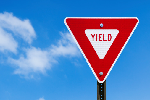 Yield sign and blue sky.