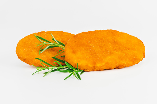 Breaded Chicken Inner Fillet, Chicken Breaded Raw Meat. Fast cooking.Breaded Chicken nuggets Fillet with salad on a White Background,food at home. Fast homemade food.Chicken breaded schnitzels.