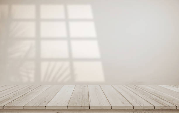 istock Minimalistic abstract gentle light beige background for product presentation with light and shadow of window and leaf curtains on wall. Pastel cream watercolor concrete wall old on floor wood parquet. 1789013212