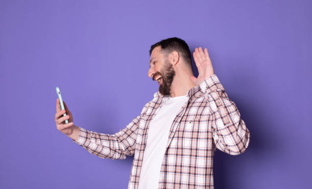 istock Handsome bearded man video calling friends, saying hello. 1789044729