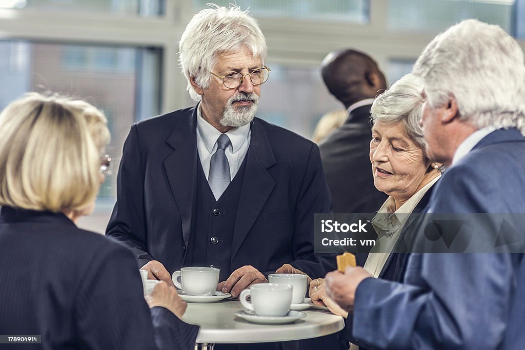 Uomini d'affari avendo una discussione durante la pausa caffè - Foto stock royalty-free di Abbigliamento da lavoro