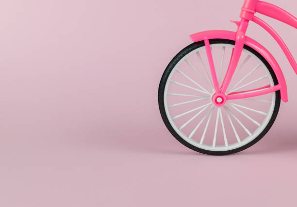 istock A toy bicycle wheel on a pink background. 1789051042