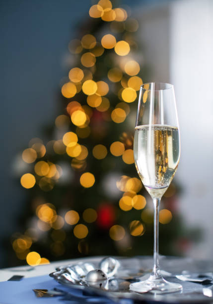 istock Glass with champagne near Christmas tree 1789103070