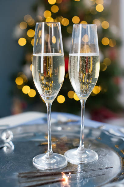 istock Glasses with champagne near Christmas tree 1789104724