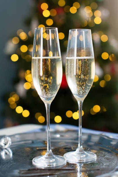 istock Glasses with champagne near Christmas tree 1789106284