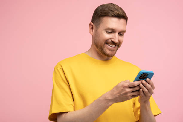 istock Smiling man looking at smartphone screen, browsing in internet, chatting with friends. 1789112099