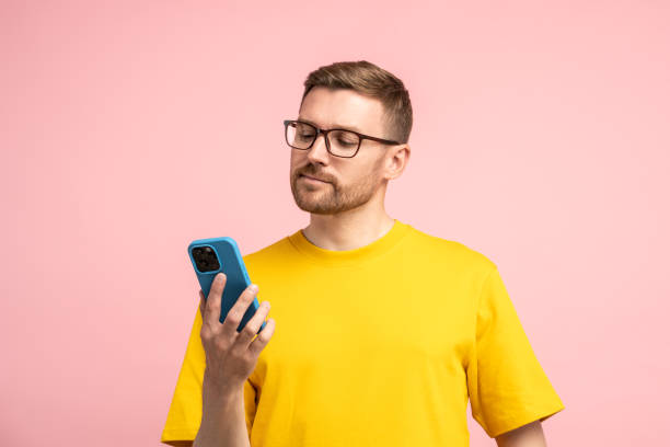istock Calm bearded man in glasses looking at mobile phone screen with composed settled satisfied face 1789112103