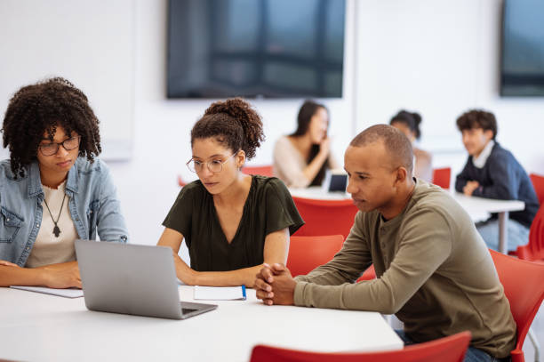 istock University students in classroom developing new scientific project. Students talking to female African professor during or after the lectures 1789127941