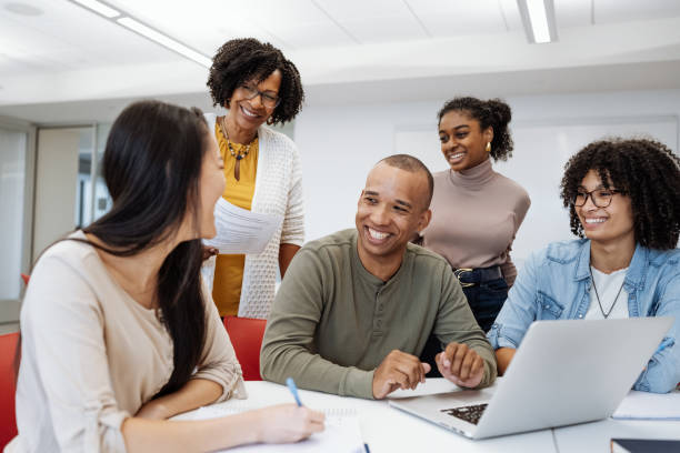 istock University students in classroom developing new scientific project. Students talking to female African professor during or after the lectures 1789128468