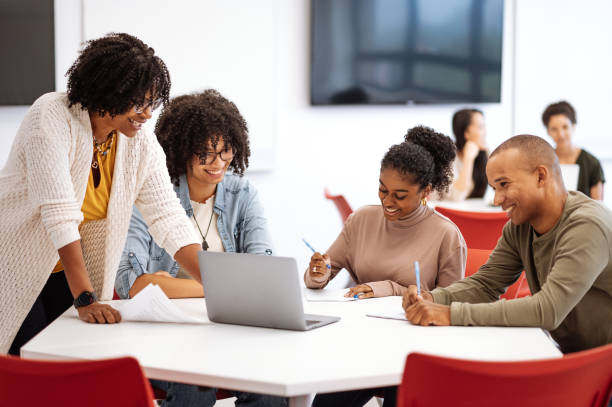 istock University students in classroom developing new scientific project. Students talking to female African professor during or after the lectures 1789129018