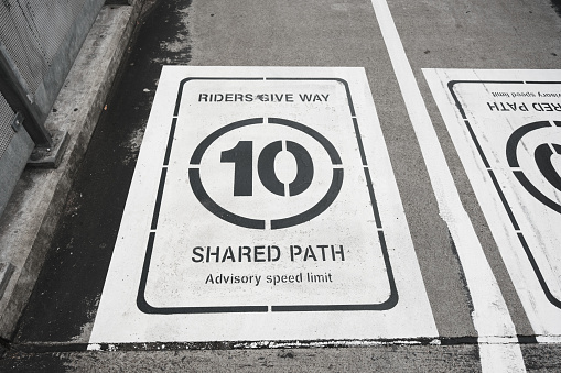 Give way sign painted on an asphalt shared pathway.