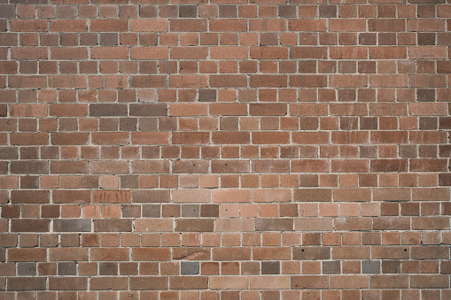Close-up on part of a brown brick wall.