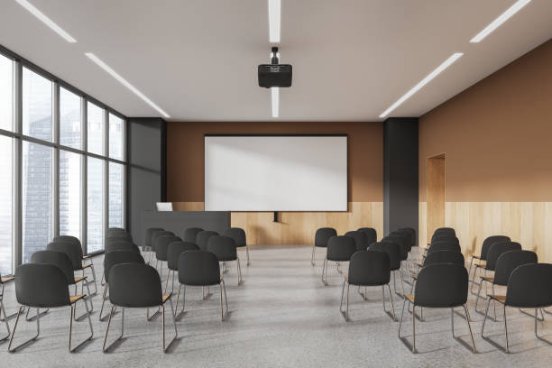 istock Beige and gray lecture hall interior with projection screen 1789146548